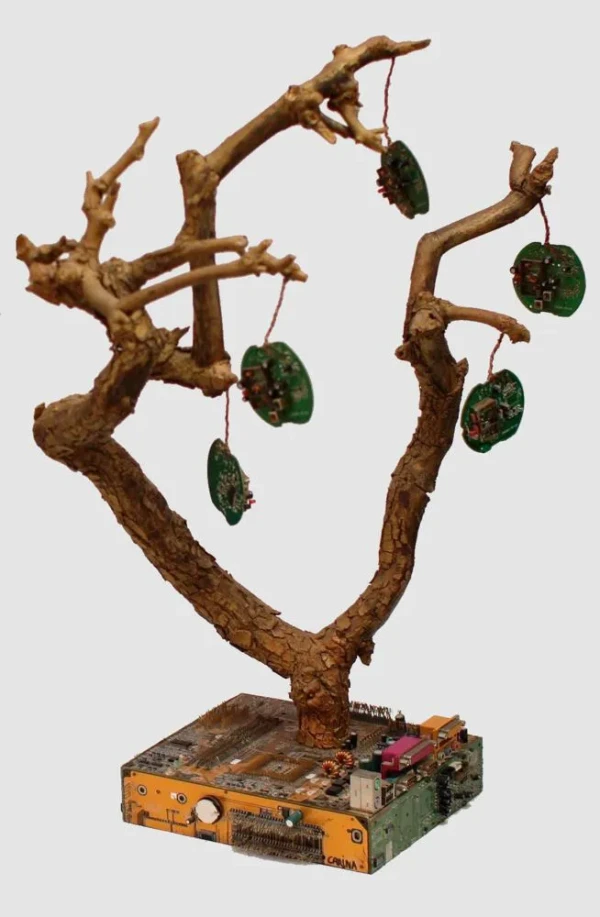 On a square base of computer motherboards, a tree of electric apples made of electronic chips grows.