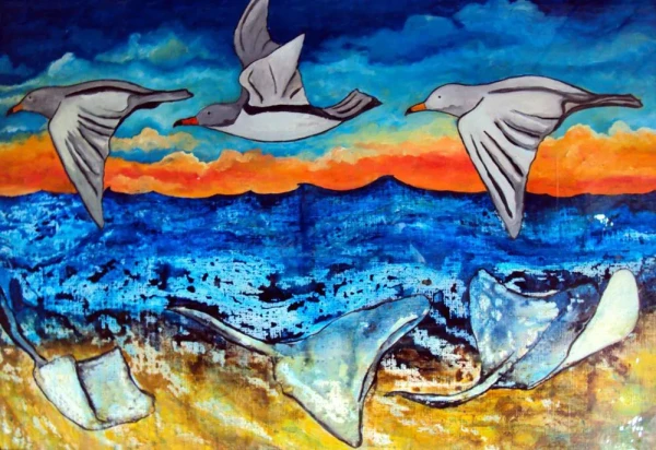 Three seagulls fly over the sea. In the sea, three manta rays swim as if they were flying.